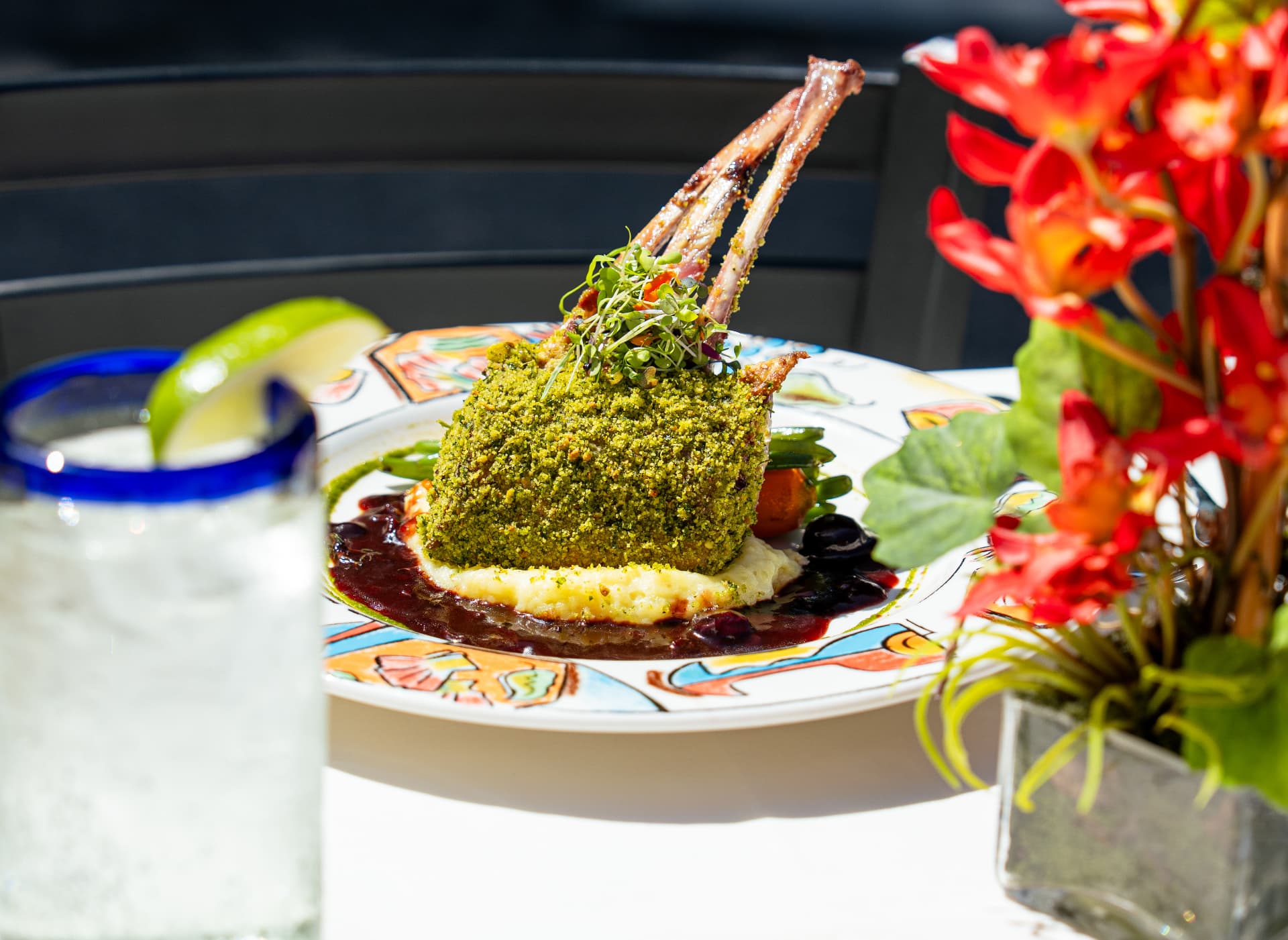 Herb-crusted rack of lamb served over creamy polenta with a red wine sauce